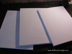 three sheets of white paper sitting on top of a table