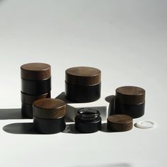 several black and brown wooden containers on a white surface with one empty container in the middle