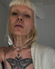 a woman with a butterfly tattoo on her chest