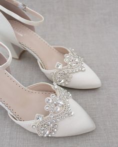 Almond toe satin block heel embellished with rhinestones applique gives just a hint of shimmer for the most stylish and elegant bride. Depending on satin color, embellishments come in silver, gold, or black rhinestones. Perfect for weddings, bridal party shoes, bridesmaids, and all special occasions. DETAILS:HEEL HEIGHT: 2.75 inchesUPPER: Synthetic upper and liningMATERIALS: Manmade outsoleSTYLE NAME: SALLY Block Heels Bridal, Bridal Party Shoes Bridesmaids, Bridal Party Shoes, Ivory Bridal Shoes, Wedding Shoes Comfortable, Bridal Flats, Elegant Heels, Satin Shoes, Wedding Flats