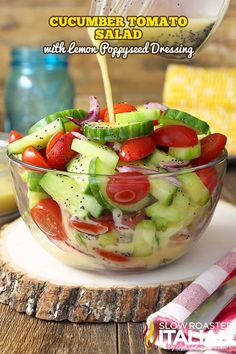 cucumber tomato salad with lemon ginger dressing in a glass bowl on a wooden table