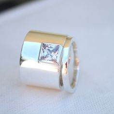 a ring with a princess cut diamond in it