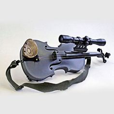 a violin that is sitting on top of a bag with a telescope attached to it