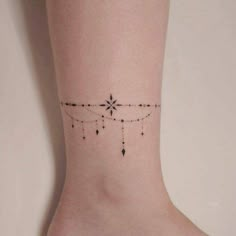 a woman's foot with a small star tattoo on the left side of her ankle