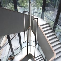 a spiral staircase in a building with glass walls