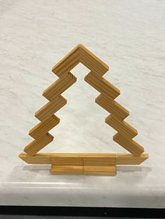 a wooden object sitting on top of a white surface