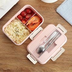 two plastic containers filled with food on top of a wooden table next to a knife and fork