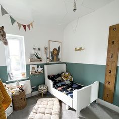 a child's bedroom with green walls and white furniture