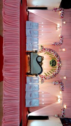 the interior of a room decorated in pink and white colors with chandeliers on the ceiling