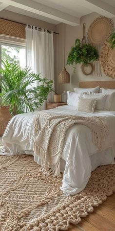 a large bed sitting in a bedroom on top of a wooden floor next to a window