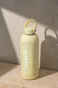 a yellow water bottle sitting on the ground