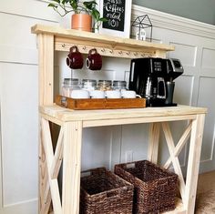 a wooden table with two baskets under it and a coffee maker on the shelf next to it