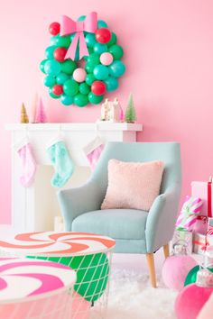 a living room decorated for christmas with pink, green and blue balloons on the wall