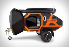 an orange and black vehicle with the door open to it's cargo compartment on wheels