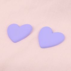 The perfect shade of bright lavender to capture spring vibes and match all your early 90's prints. Heart-shaped stud earrings in a fun puffy type of acrylic that looks a bit like polymer clay but is lighter weight so won't weigh down your ears. 1.37 inches (3.5 cm) long and 1.57 inches (4 cm) wide Stainless steel studs Lightweight matte finish acrylic (looks and feels a bit like polymer clay, but lighter weight)