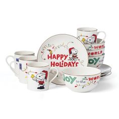 a set of white dishes with snoopy characters on them and the words happy holidays written in red