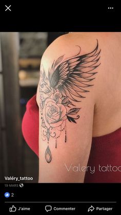 the back of a woman's shoulder with an angel and rose tattoo on it