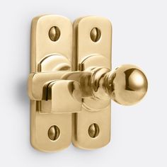 a golden door handle on a white background