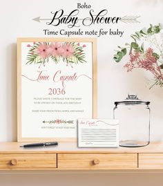 the baby shower time capsule note for baby is displayed next to a vase with flowers