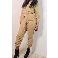 Tan Denim Jumpsuit Front O-Ring Zipper With Self-Tie Waist And Collared Neckline. Cropped Length Model Wears: Medium/ Waist 27"/ Bust 34c/ Height 5'7/ Hips 41" Fabric: 100% Cotton Casual Cotton Belted Jumpsuits And Rompers, Casual Belted Overall Jumpsuits And Rompers, Casual Belted Jumpsuits And Rompers For Day Out, Casual Overalls Jumpsuits For Fall, Casual Overalls And Rompers For Fall, Trendy Relaxed Fit Jumpsuits And Rompers For Fall, Relaxed Fit Jumpsuits And Rompers For Fall Day Out, Fall Day Out Relaxed Fit Jumpsuits And Rompers, Trendy Khaki Jumpsuits For Spring