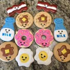 decorated donuts are arranged in the shape of smiley faces