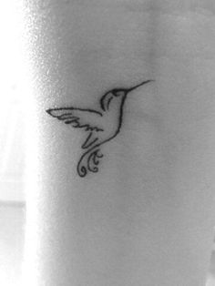 a small hummingbird tattoo on the ankle