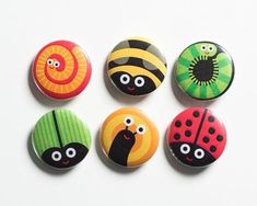 six buttons with different designs on them