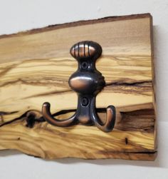 a metal hook is attached to a wooden board