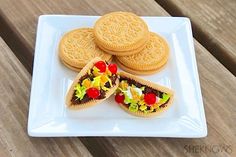 a white plate topped with two sandwiches and crackers