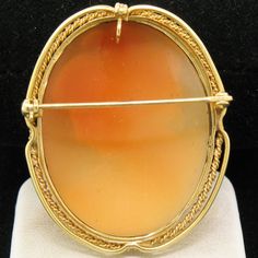 Here we have a very nice vintage cameo pendant or brooch. The frame is solid 14k yellow gold and features two gold wires, a twisted gold wire nearest the cameo and a straight gold wire at the outside edge. The pin and locking mechanism on the back are in perfect working order. The bail on the back of the piece swivels up for wear as a pendant or down when wearing it as a brooch. The inside of the bail is approximately 2.9mm in diameter. (Please be sure to take into account areas of a clasp that Oval Yellow Gold Brooches With Gemstone, Oval Cabochon Brooches For Anniversary, Heirloom Oval Brooch Jewelry, Oval Cameo Brooch For Anniversary, Gold Oval Cameo Brooch, Classic Oval Cameo Brooch, Classic Oval Brooch Jewelry, Antique Oval Cabochon Brooches, Vintage Yellow Gold Oval Brooch