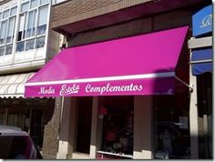 a pink awning on the side of a building