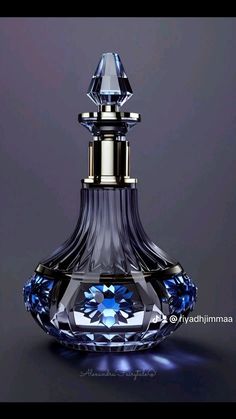 a blue glass perfume bottle with a diamond on it's top and the bottom