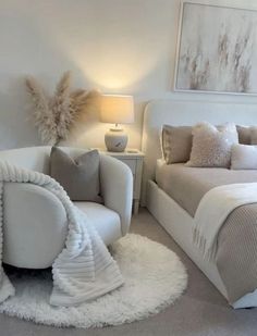 a bedroom with white furniture and pillows on the bed