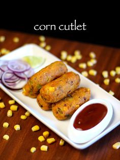 corn cutlets with ketchup and onion on a plate next to some condiments