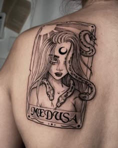 the back of a woman's shoulder with an image of medusa on it