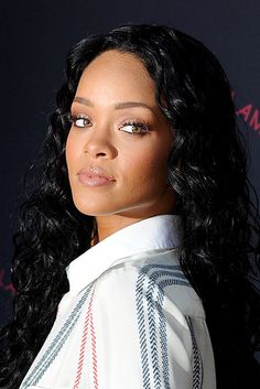 a close up of a person wearing a white shirt and long black hair with bangs