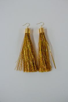 Gift yourself or a friend a unique set of gold metallic tinsel tassel earrings for a special occasion. They feature 18K gold and a gold tinsel fringe that dangle perfectly from your ears for a spectacular look. Fringe is very soft! Materials: 18K gold hook, gold tinsel fringe Fringe Length: 3in Gold Tassel Earrings With Beaded Fringe, Gold Fringe Tassel Earrings For Festival, Cheap Gold Metal Tassel Earrings, Tinsel Tassel, Affordable Gold Metal Tassel Earrings, Gold Metal Fringe Tassel Earrings, Fringe Earrings, Tassel Earrings, Custom Items