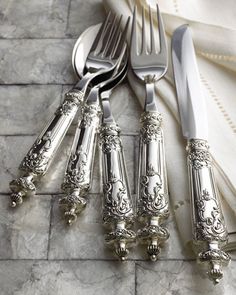 an assortment of silverware sitting on top of a table