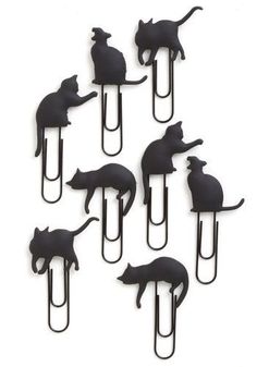 six black cats sitting on top of a metal hook