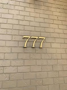 the number 777 on a brick wall