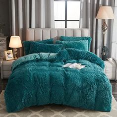 the comforter is made up in teal colors