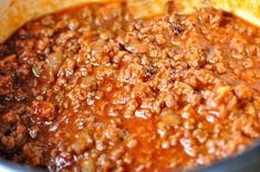 a pot filled with chili and bread on top of a stove