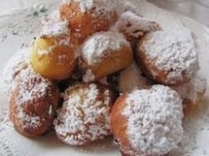 powdered sugar covered pastries on a doily