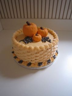 there is a cake with two pumpkins on it