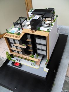 a model of a building with cars parked in front of it