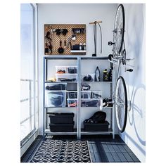 a bike is mounted to the wall in a room with shelves and bins on it