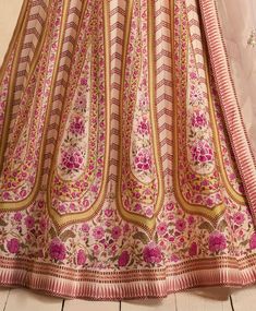 COLOR : Desert Sand FABRIC : Top (Blouse) - Premium Silk, Bottom (Lehenga) - Premium Silk, Inner - Cancan, Dupatta - Organza WORK : Silk Thread Embroidery, Sequins, Digital Print, Floral Motifs, Lace Border OCCASION : Wedding, Reception, Sangeet, Engagement READY-TO-WEAR : NoSTITCHING : Available as semi-stitched fabric, can be stitched using standard size option (+$30). Note: There might be a slight color variation due to lighting and flash used during photoshoot. The bright shade seen is the b Unstitched Wedding Choli With Motifs, Fitted Embroidered Fabric With Motifs For Reception, Unstitched Lehenga With Motifs For Wedding, Unstitched Wedding Lehenga With Motifs, Fitted Sharara With Motifs For Reception, Wedding Sets With Pink Motifs, Fitted Floor-length Sharara With Motifs, Fitted Pink Anarkali Set With Motifs, Fitted Lehenga With Motifs For Reception