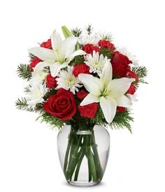 a vase filled with white and red flowers