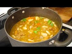 a pot filled with soup sitting on top of a stove