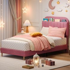 a bedroom with pink bedding and white walls, decorated with stars on the wall